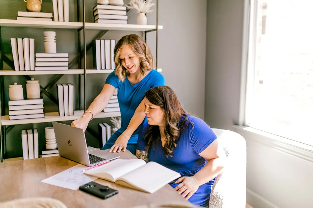 Two people working together with a laptop