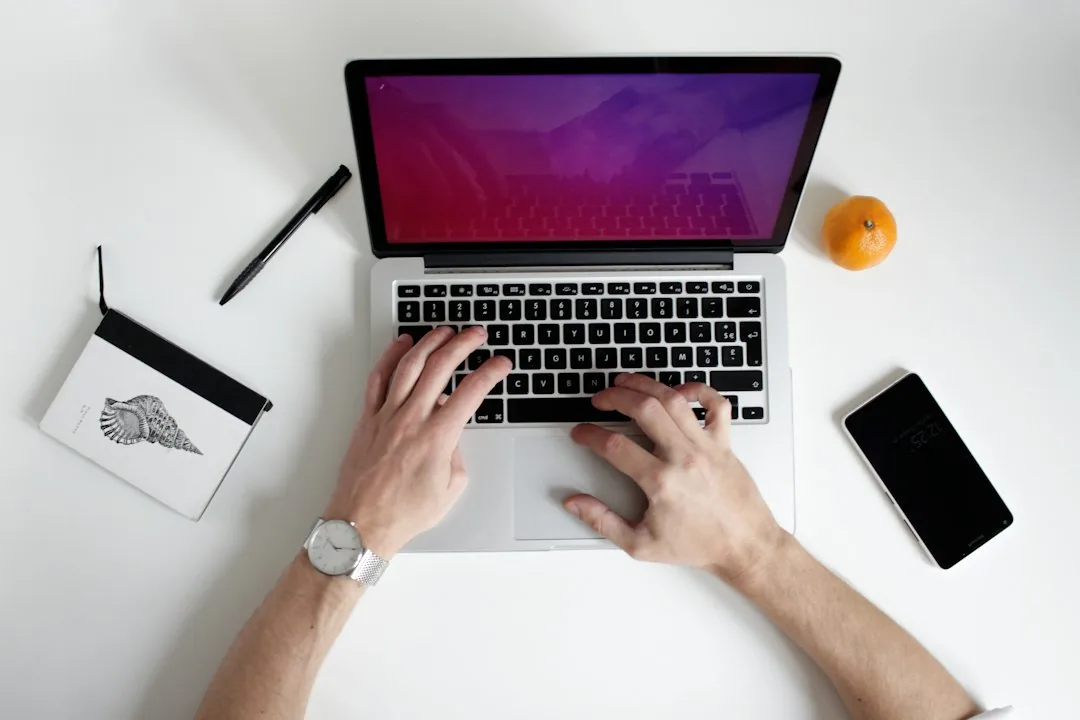 A laptop and notebook in a working space